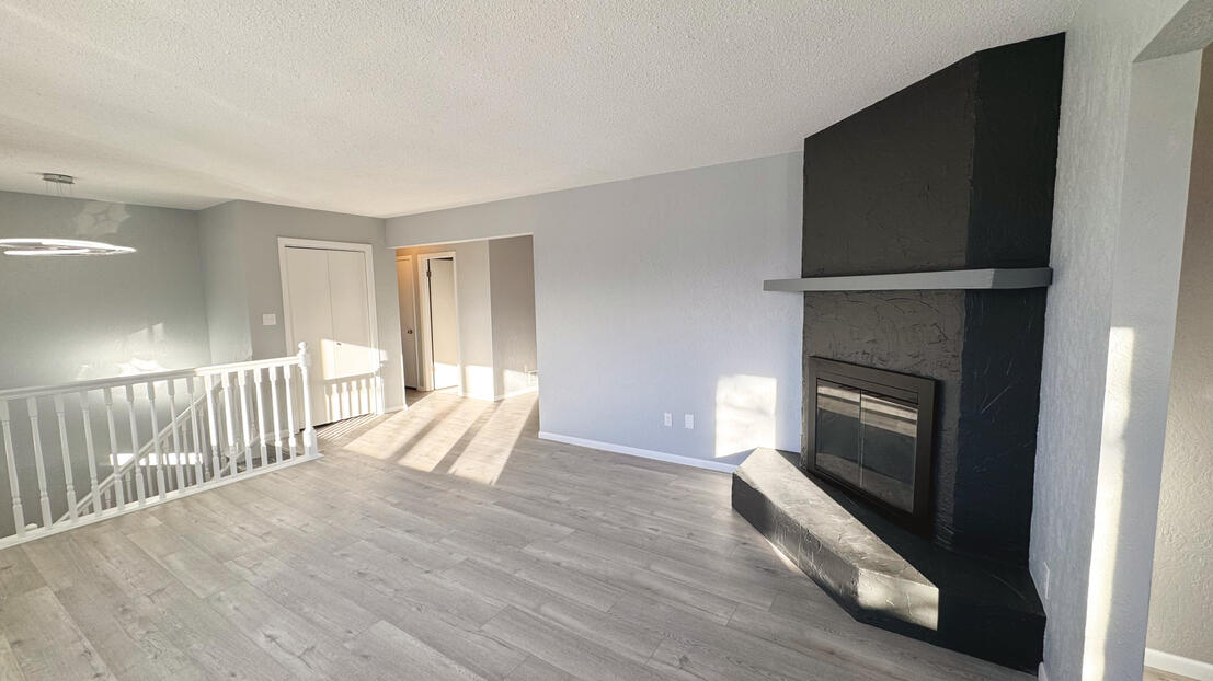 Entryway view looking up the newly painted white staircase railings to the modern living area, by Bismarck’s father and son team